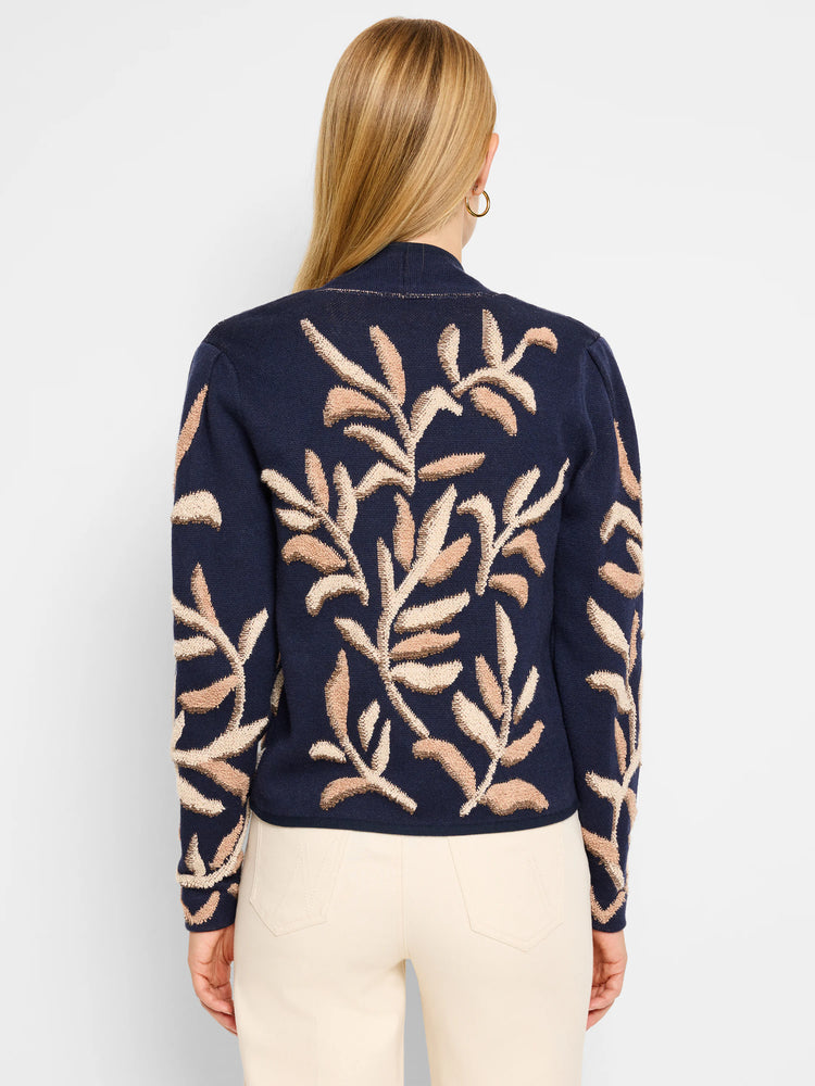 Dark blue knit jacket, back view.  Features a tufted, beige and brown leaf pattern.
