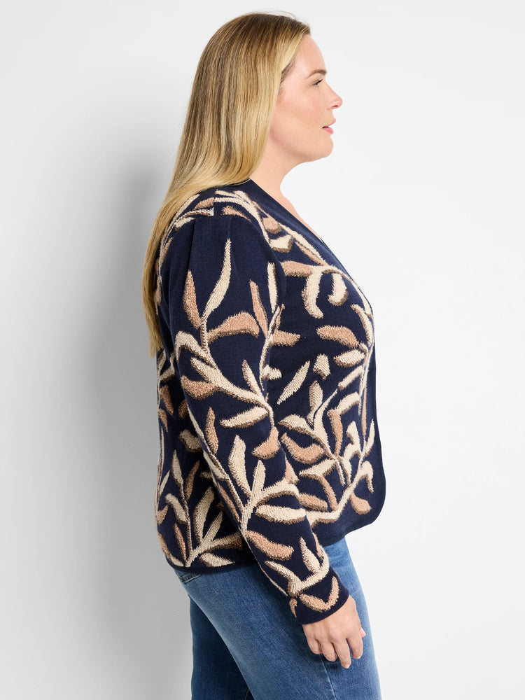 Dark navy blue knitted jacket with beige and tan leaf pattern.  Side view.