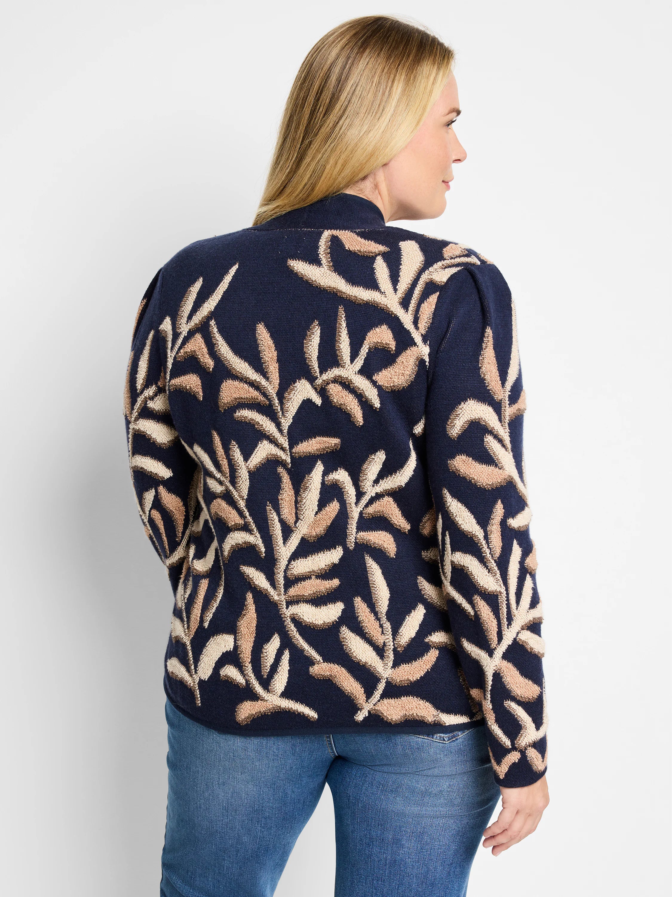 Dark blue knit jacket with a beige and brown leaf pattern.  Mock neck.