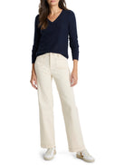 Navy V-neck sweater with ribbed collar and cuffs, shown on a model.