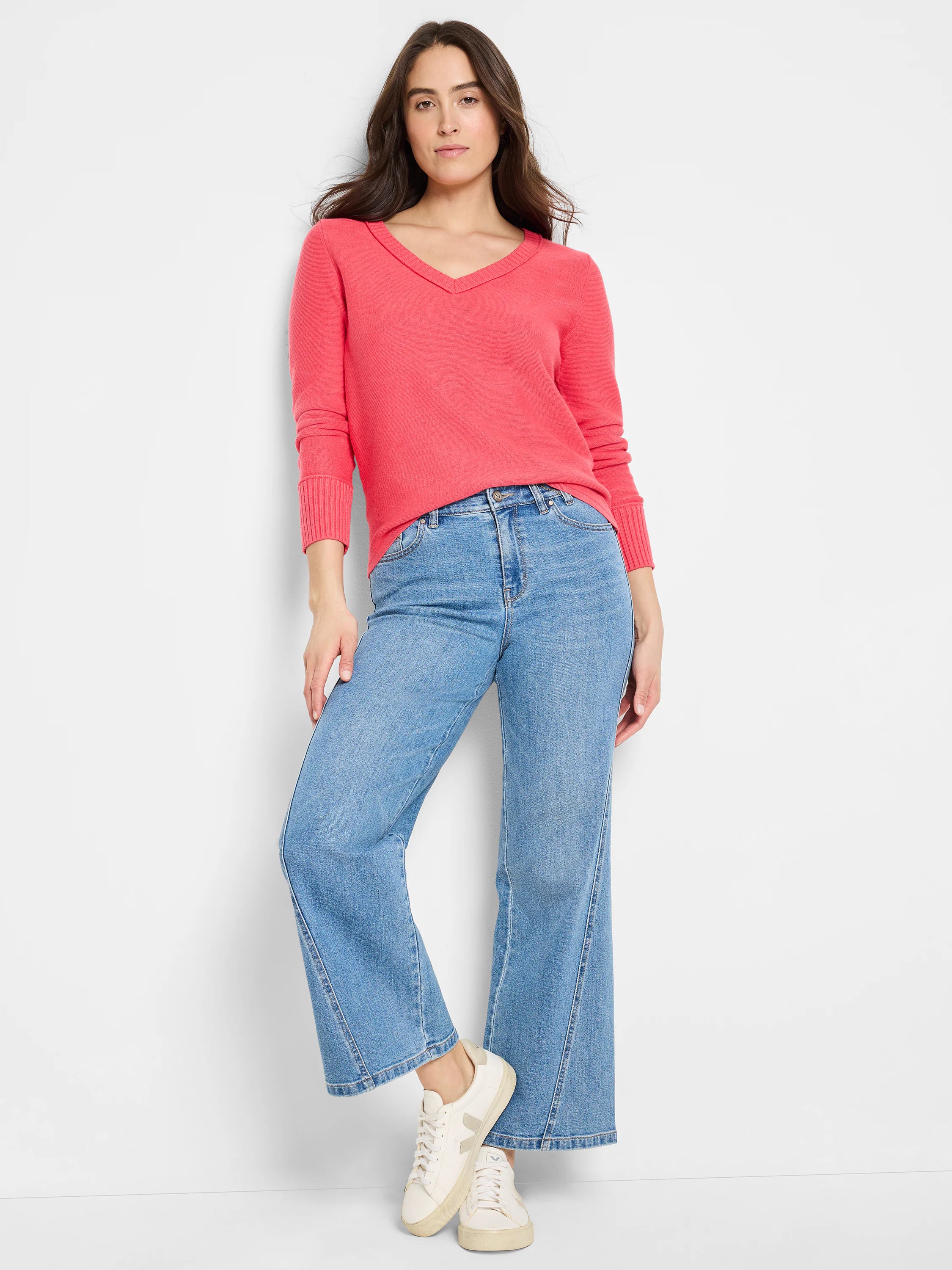 Coral V-neck sweater with long sleeves and subtle garter knit texture.