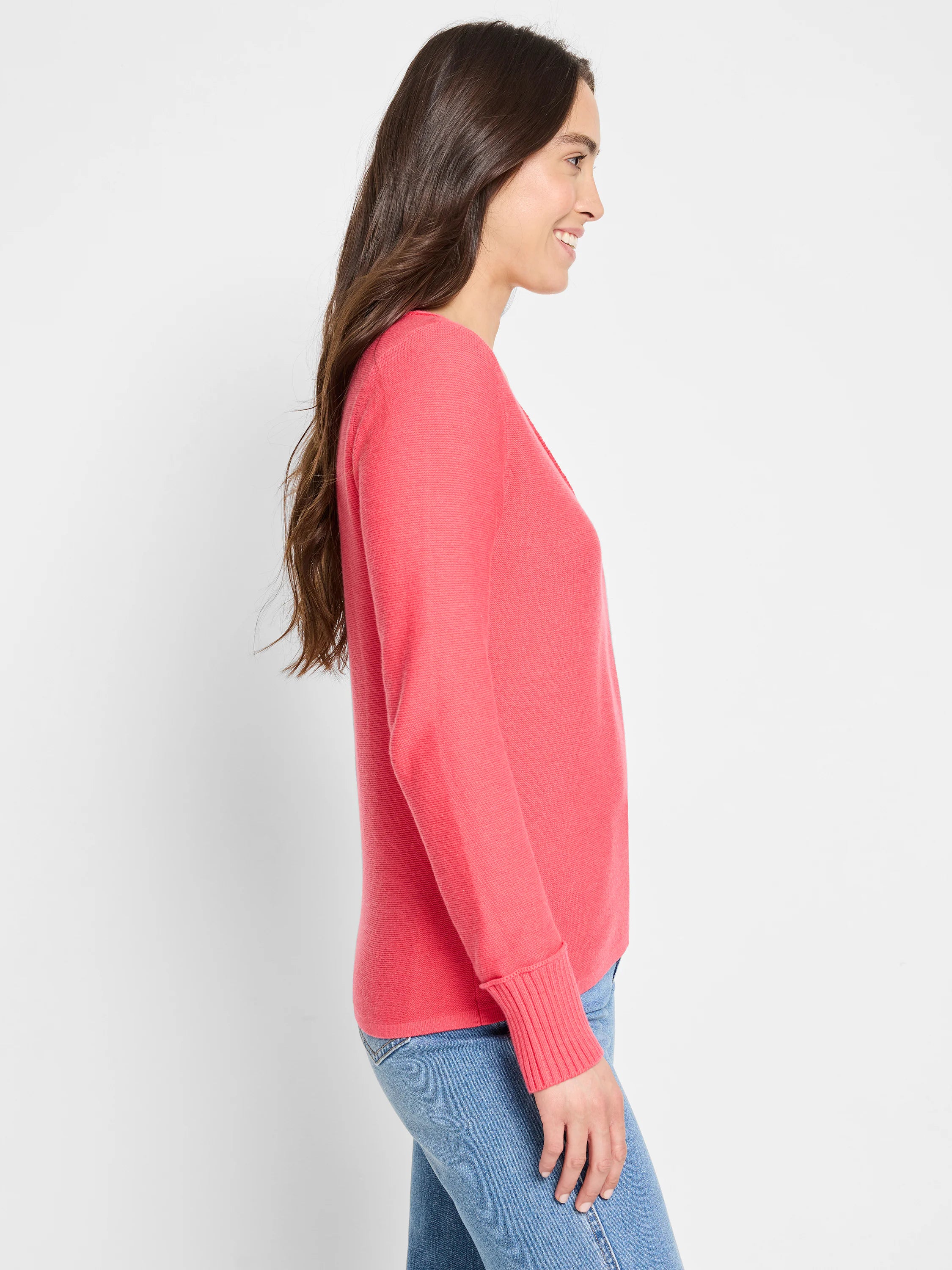 Coral pink V-neck garter stitch sweater with long sleeves and ribbed cuffs.