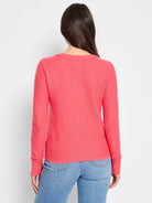 Back view of a salmon pink fine knit sweater with long sleeves, ribbed crew neck collar and cuffs.