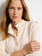 Off-white button henley sweater.  Knit fabric, off-white buttons.