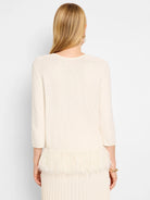 Off-white sweater, 3/4 sleeves.  Bottom features a white feather fringe.