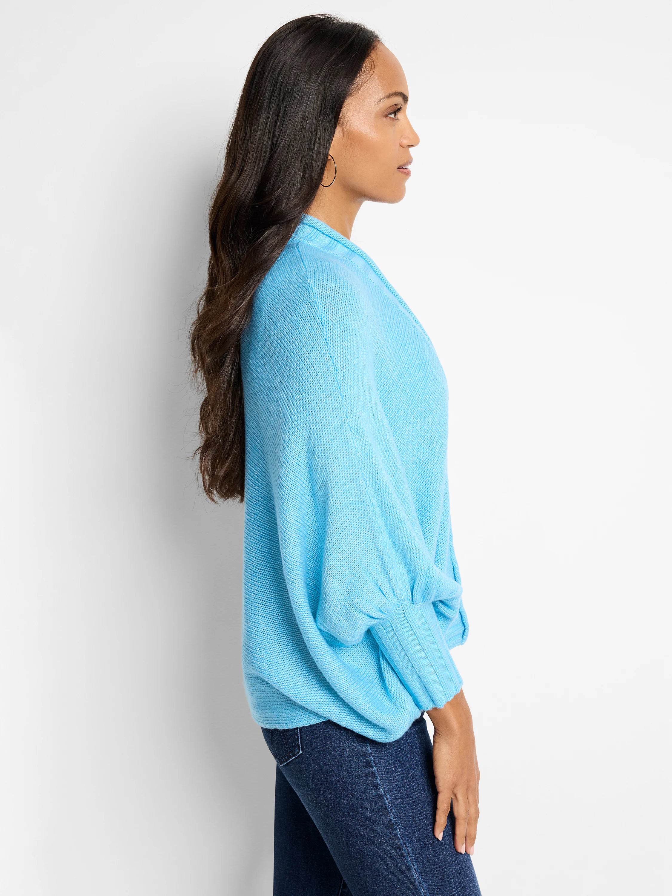 Light blue knit cardigan,  loose fit, long sleeves with slightly puffed cuffs.