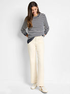 Cream and navy blue horizontally striped sweater.  Long sleeves, crew neck.