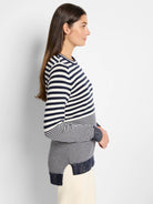 Image of cream and navy blue horizontally striped, long-sleeved cotton cashmere sweater.  Side view.