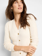 Off-white ribbed knit cardigan with gold buttons and v-neck. Long sleeves.