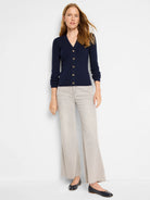 Navy blue ribbed cardigan, V-neck, gold buttons.