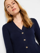 Navy blue ribbed knit sweater, V-neck, three gold toggle buttons.