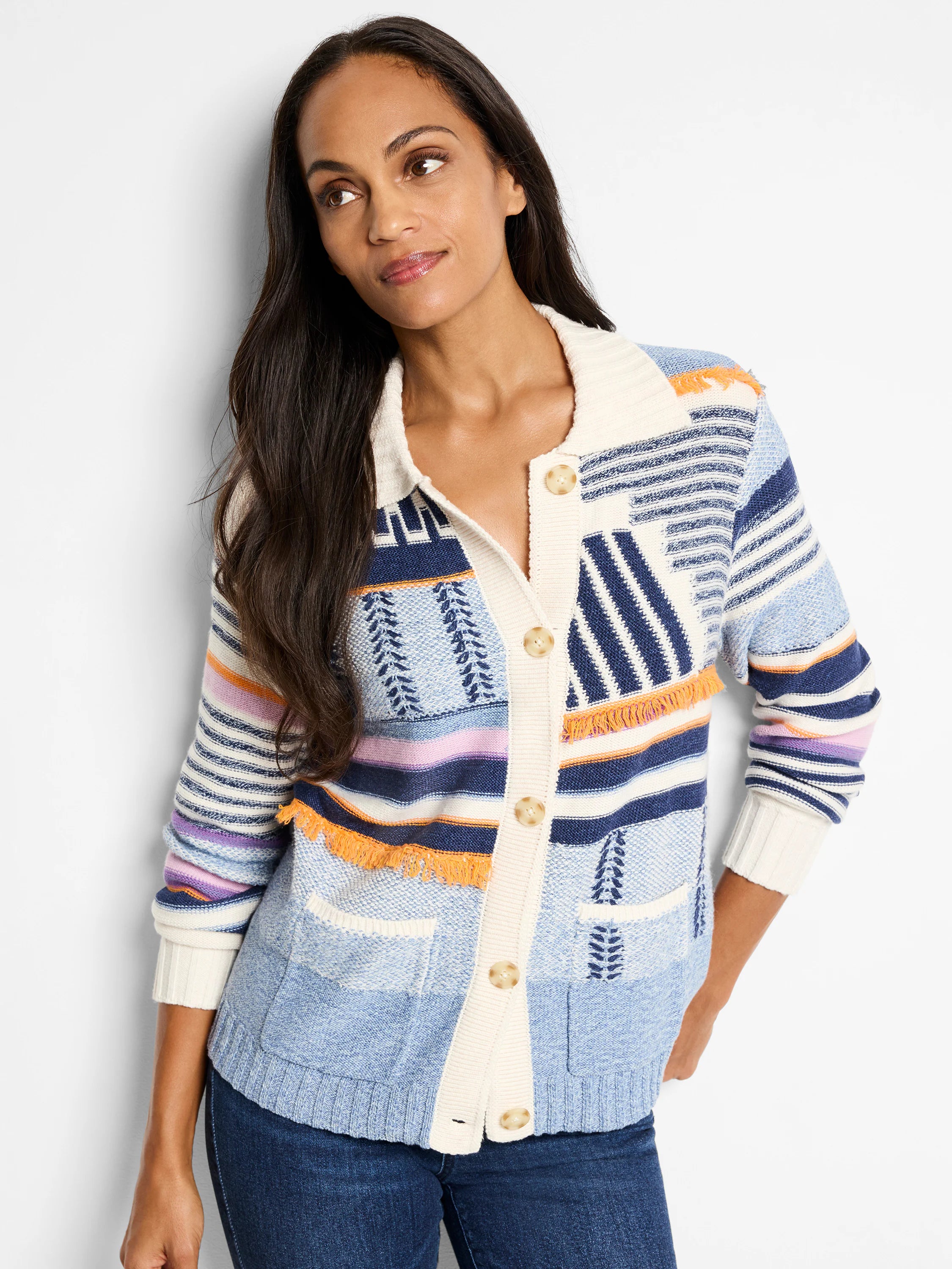 Button-front sweater jacket in blue, white, navy, orange, and purple stripes and patterns. Features fringe detailing.