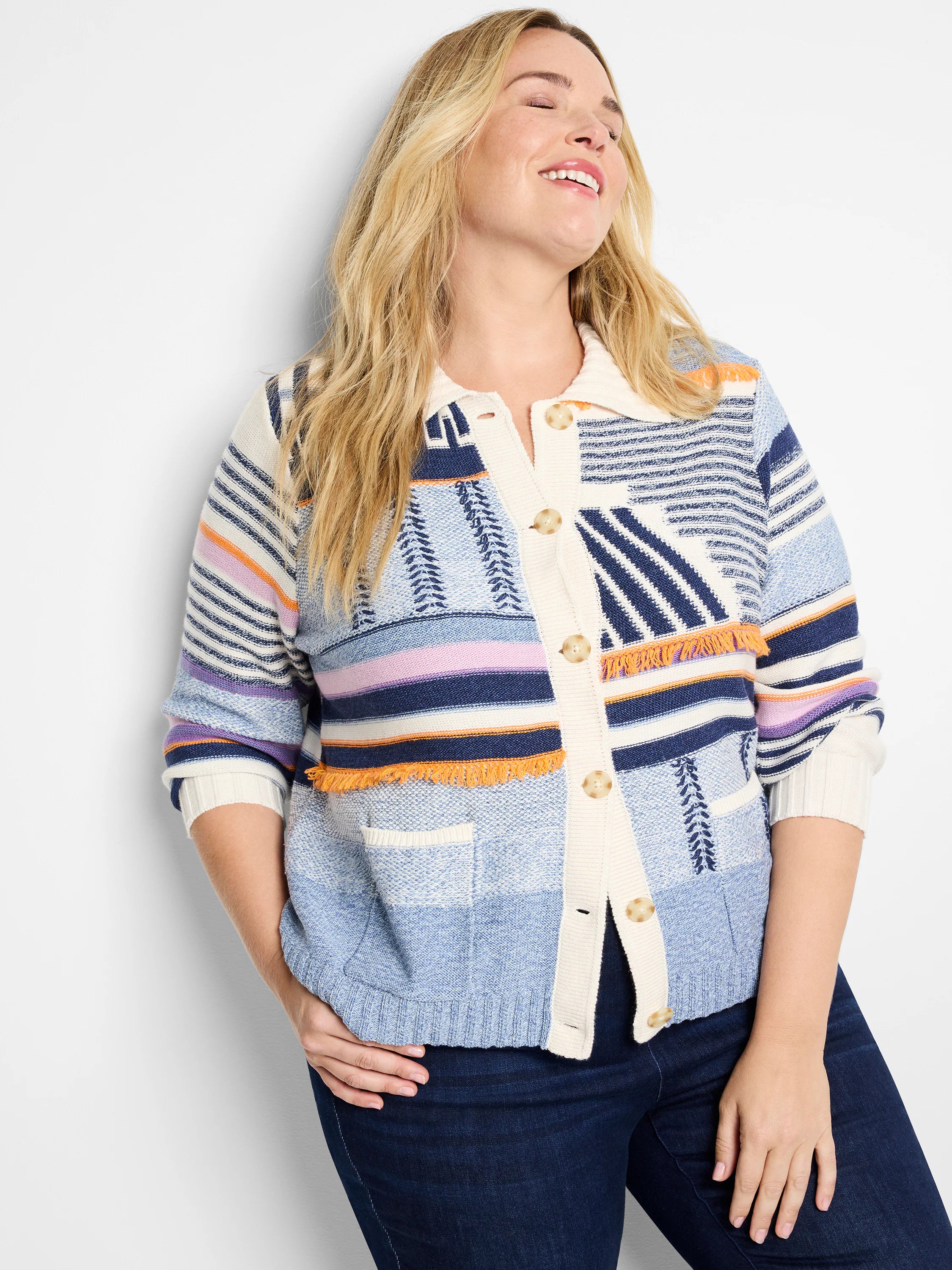 Blue, white, navy, orange, and purple patterned cardigan sweater jacket with fringe detail and buttons.