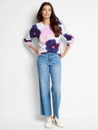 Cream, pink, purple, and dark blue abstract floral pattern on a long-sleeved crewneck sweater.