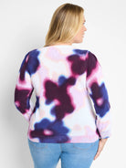 Cream sweater with purple, pink, and blue abstract tie-dye pattern. Long sleeves, crew neck.