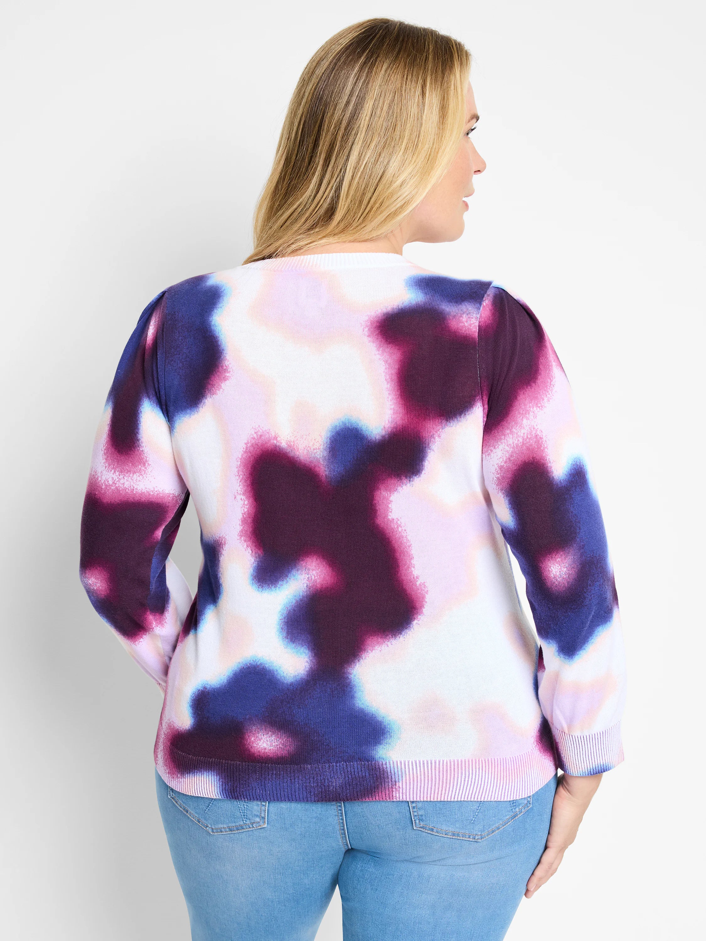 Cream sweater with purple, pink, and blue abstract tie-dye pattern. Long sleeves, crew neck.