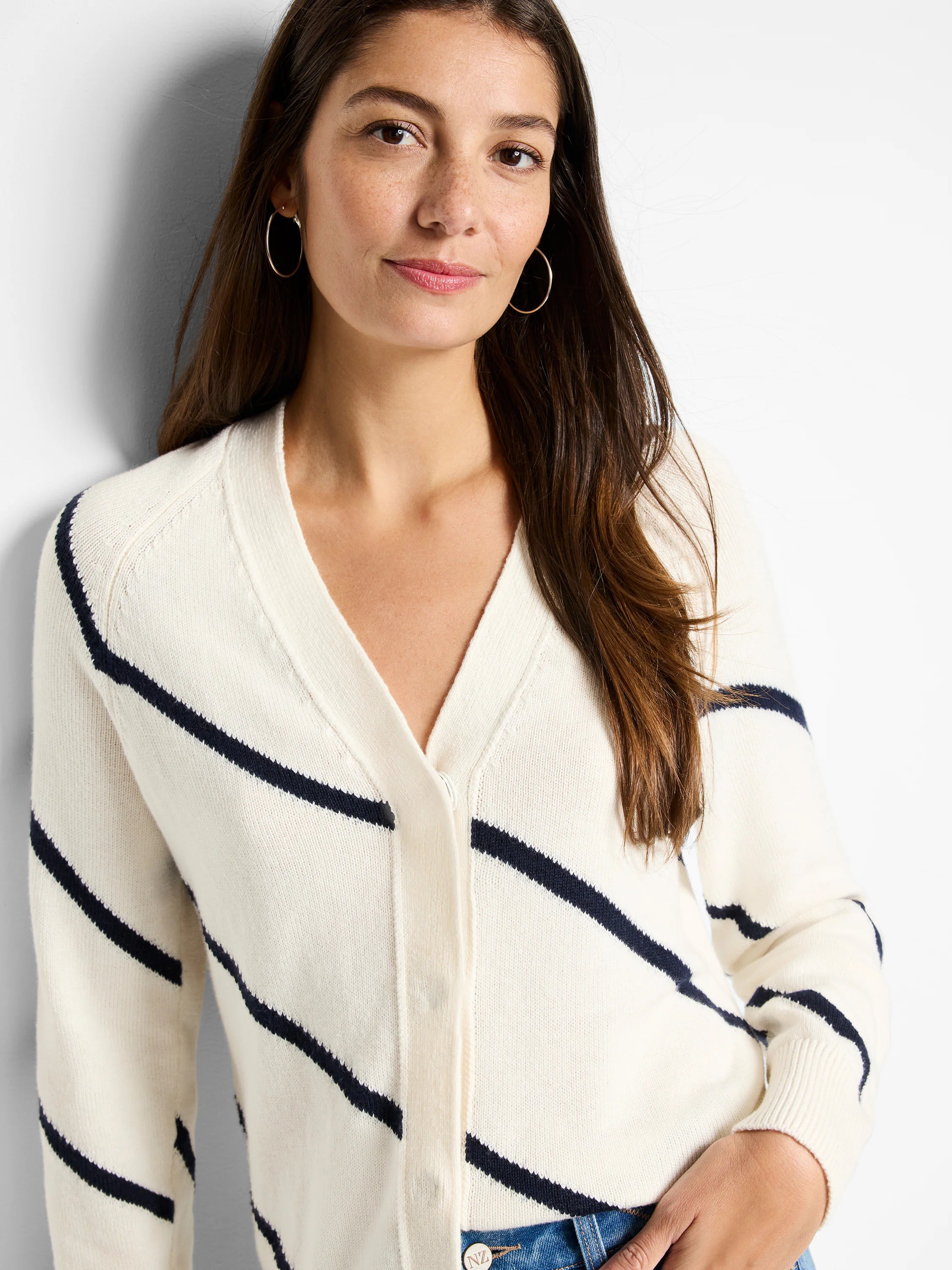 Cream-colored cardigan with diagonal navy stripes, V-neck, and button closure.