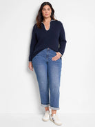 Navy blue sweater with off-white collar and cuffs.  Long sleeves, V-neck.