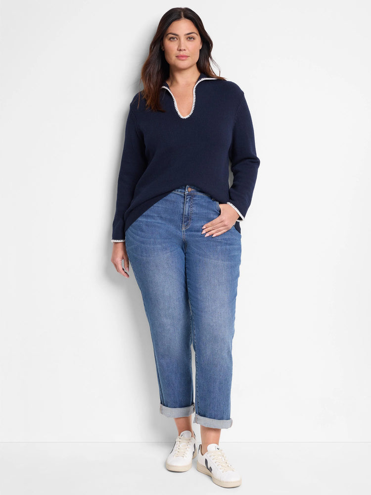 Navy blue sweater with off-white collar and cuffs.  Long sleeves, V-neck.