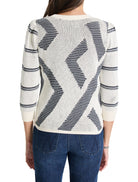 Cream-colored sweater with dark-blue, abstract, diagonal pattern.  Three-quarter sleeves.