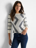 Cream-colored sweater with dark gray/navy diagonal stripes and pattern. Three-quarter sleeves, crew neck.