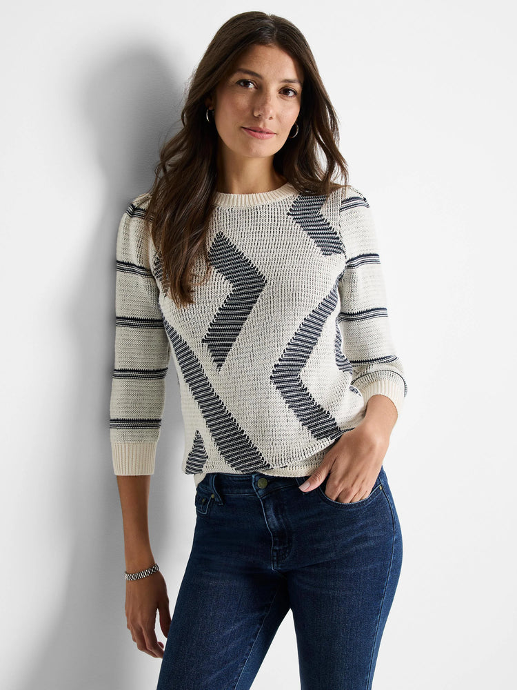 Cream-colored sweater with dark gray/navy diagonal stripes and pattern. Three-quarter sleeves, crew neck.