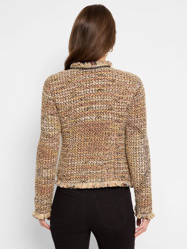 Multi-color knit jacket in beige, yellow, black, and pink. Features fringe trim at hem/cuffs and a black chain collar.