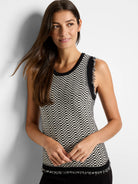 Black and off-white knit tank top with a textured, geometric pattern and frayed hem. Sleeveless.