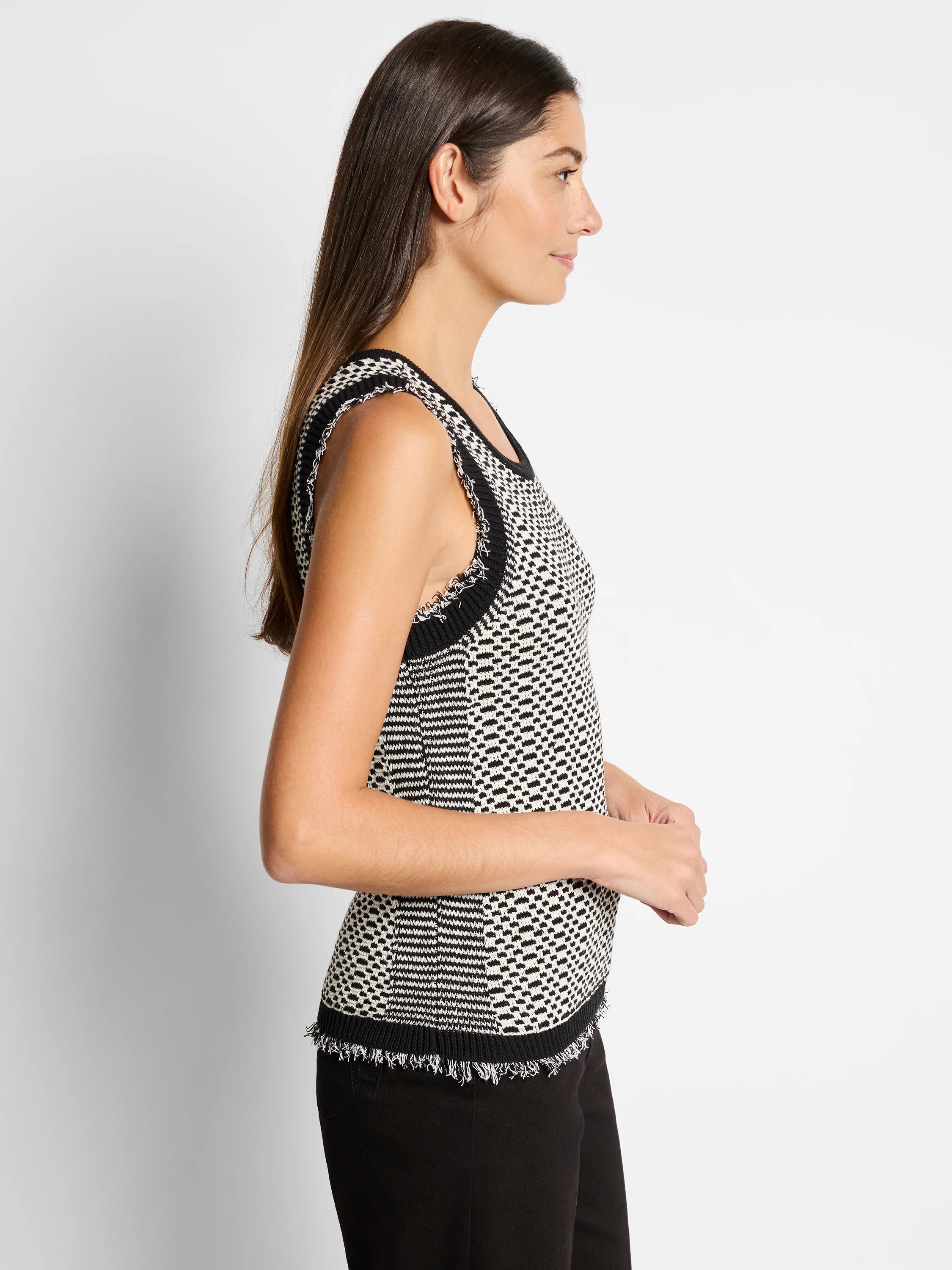 Black and cream knit tank top with a textured pattern and frayed edges. Sleeveless.