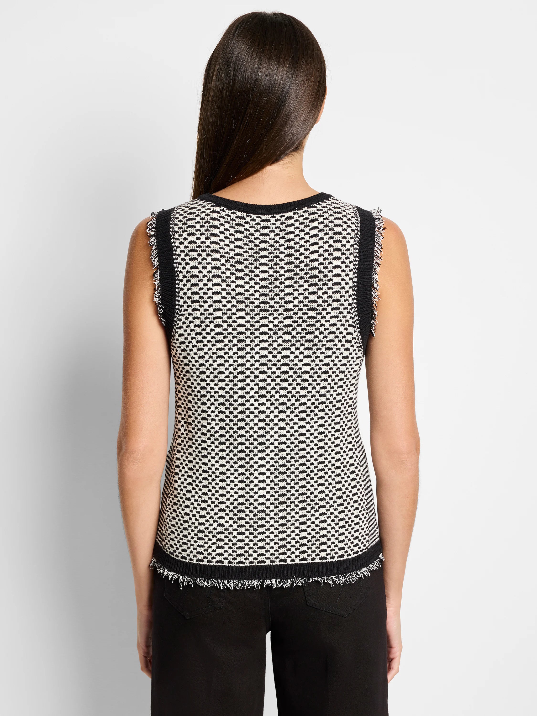 Black and off-white knit sleeveless tank top. Geometric pattern.  Frayed edges.