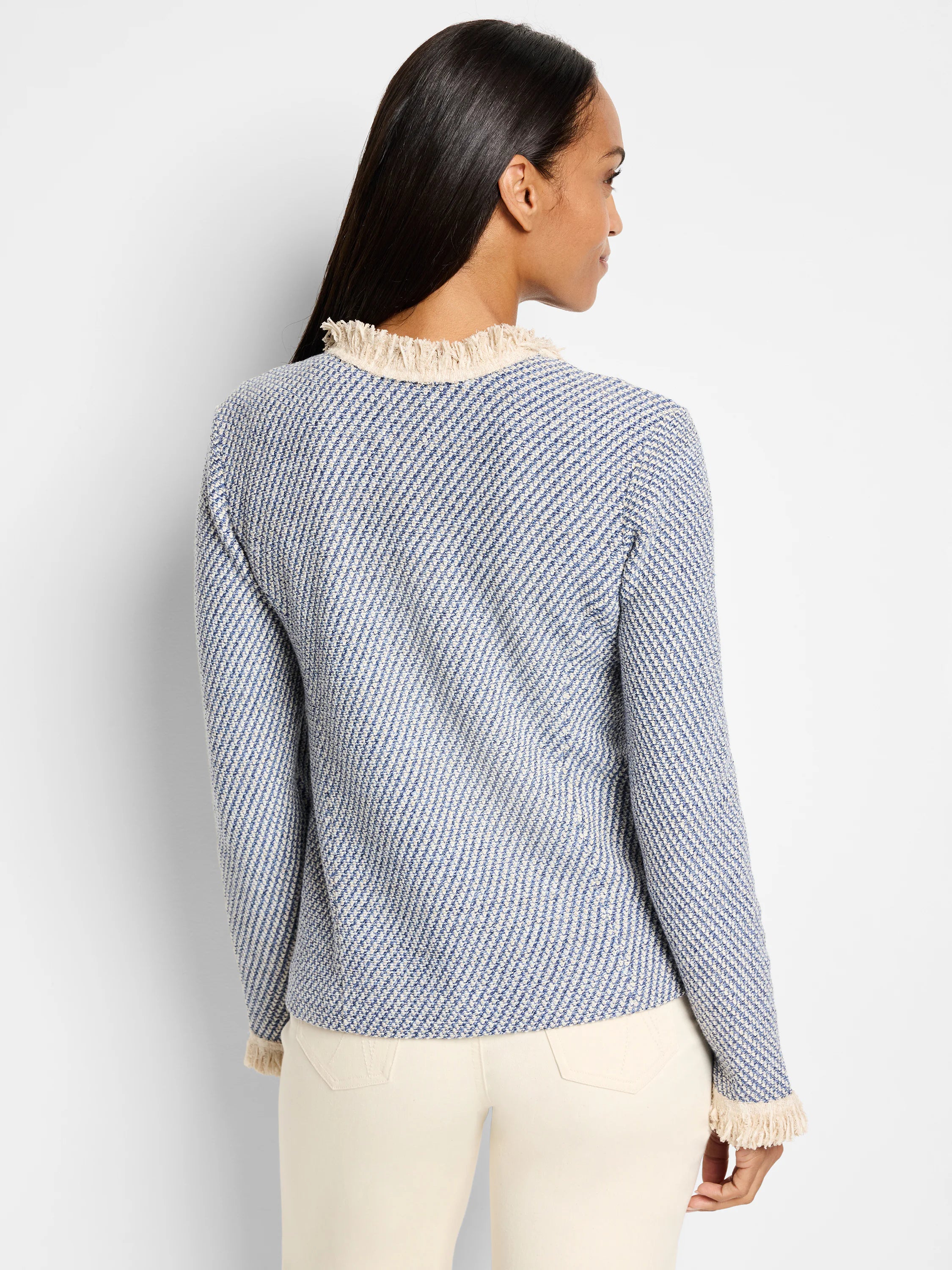 Blue and cream tweed jacket with fringe trim at neckline and sleeves.  Back view.