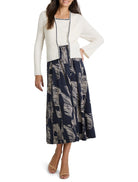 Off-white ribbed tank with dark trim.  Model wears it with a navy and beige patterned midi skirt.