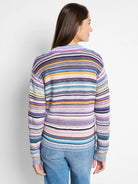 Multicolored striped sweater.  Purple, blue, pink, and yellow stripes on a white background. Long sleeves, crew neck.