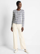 Off-white knit jacket with a navy blue geometric pattern, button closure.