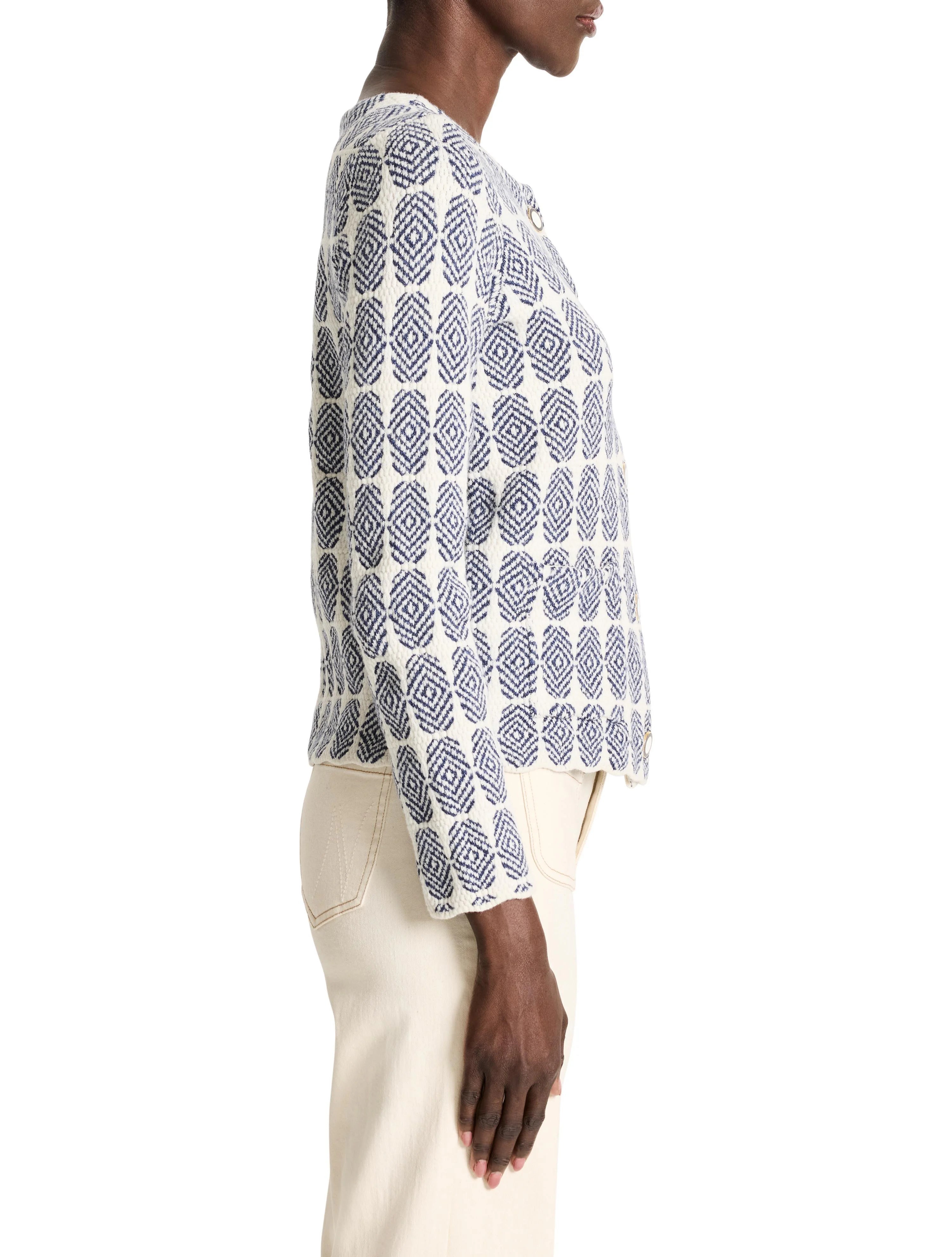 Off-white knit jacket with a navy blue geometric pattern.  Side view.