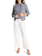 Blue and white tweed jacket, cropped sleeves, frayed edges, single button closure.