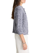 Blue and white speckled knit sweater jacket.  Three-quarter sleeves, frayed hem.