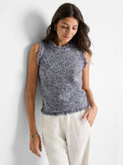 Sleeveless, navy and white speckled knit tank.  Features a frayed hem and armholes.