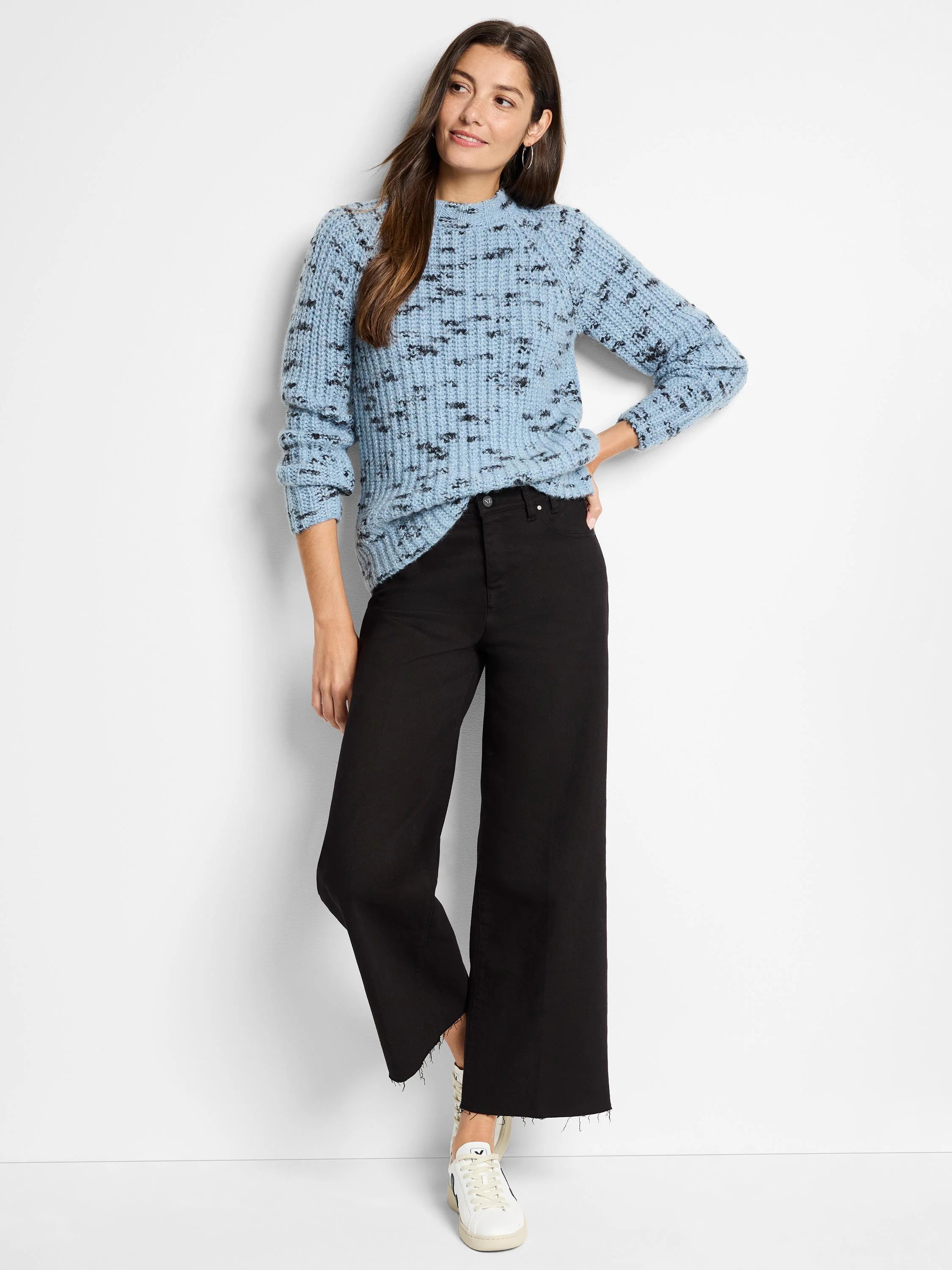 Light blue sweater with dark speckles, mock neck, long sleeves.