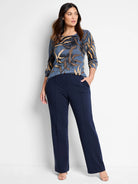 Blue sweater with brown and beige leaf pattern. Long sleeves.