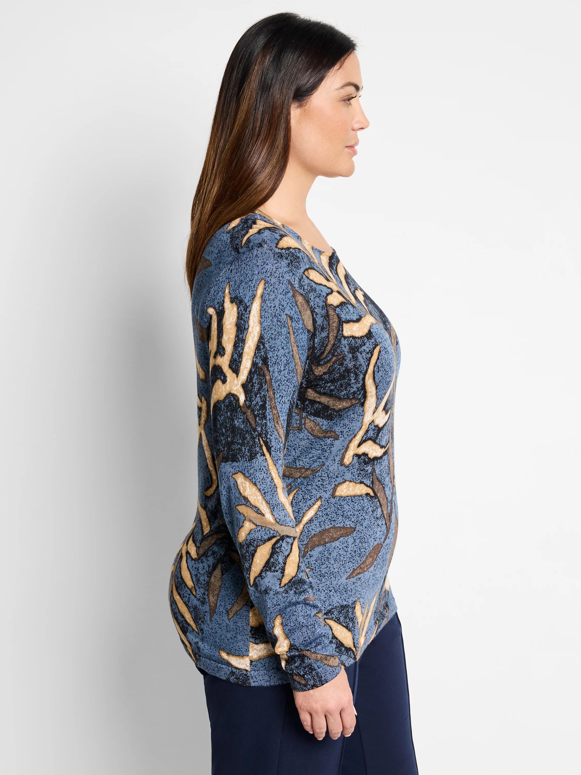 Blue sweater with beige and brown leaf print. Long sleeves.