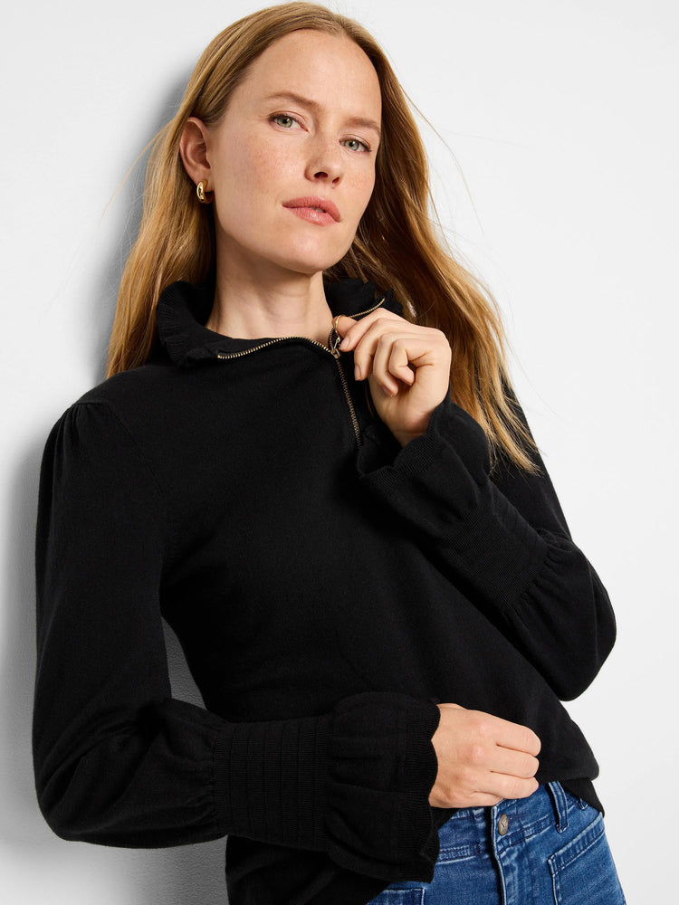 Black half-zip sweater with ruffled collar and cuffs.  Long sleeves.