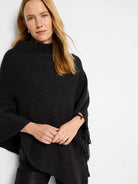 Black poncho with metallic flecks and fringe detail.