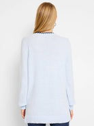 Light blue long-sleeve sweater with a dark trim at the neckline.  The sweater is shown from the back.