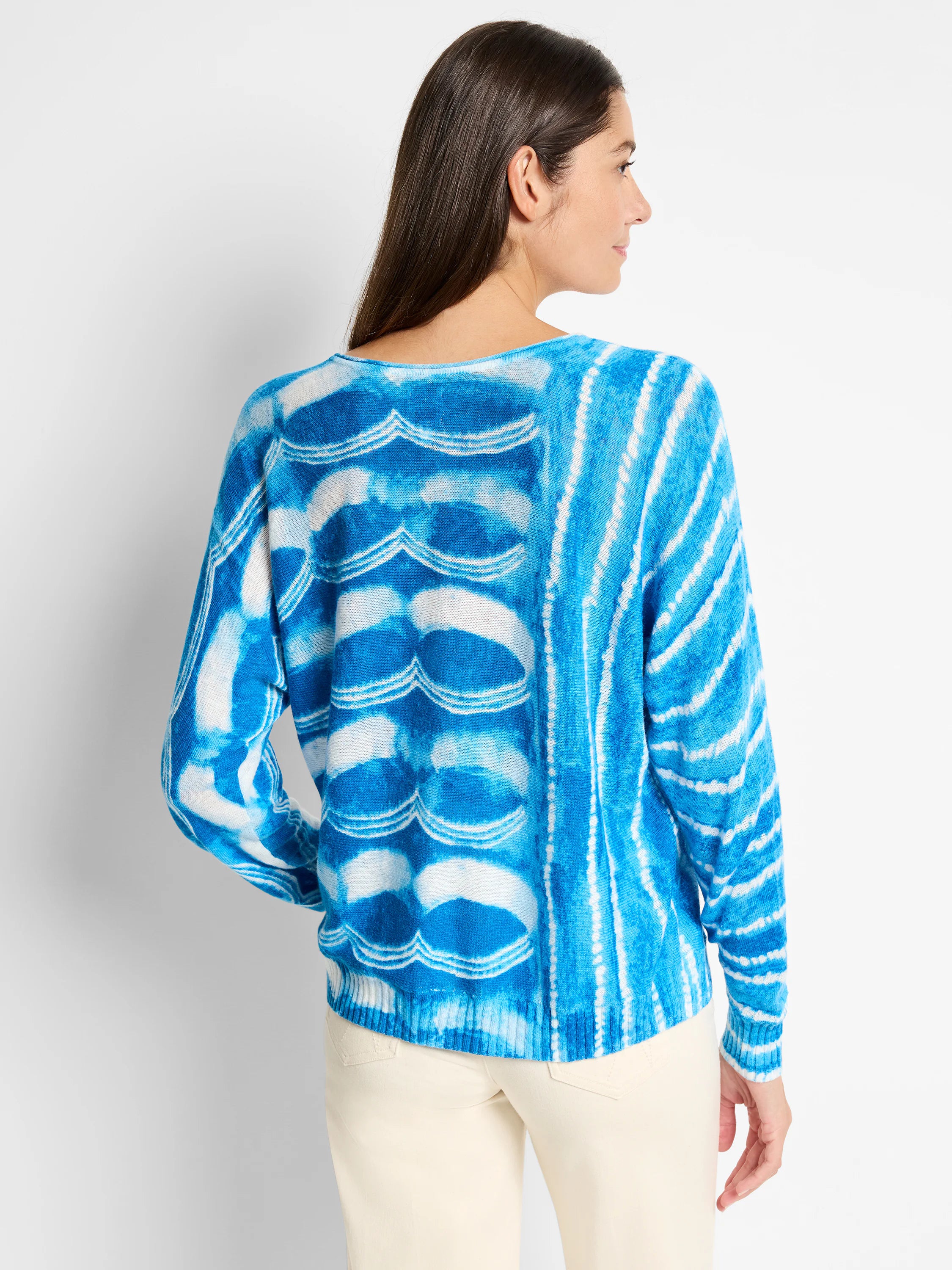 Blue and white tie-dye pattern long-sleeved knit sweater.  Back view shown.