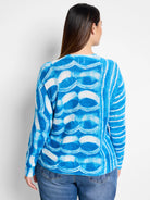 Blue and white tie-dye pattern sweater.  Wave-like design. Long sleeves.