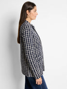 Navy blazer with an off-white grid pattern.  Long sleeves, collared.