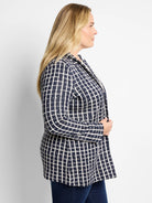 Navy blazer with an off-white plaid pattern.  Open front, long sleeves.