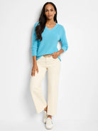 Light blue, V-neck, long sleeves, ribbed knit.