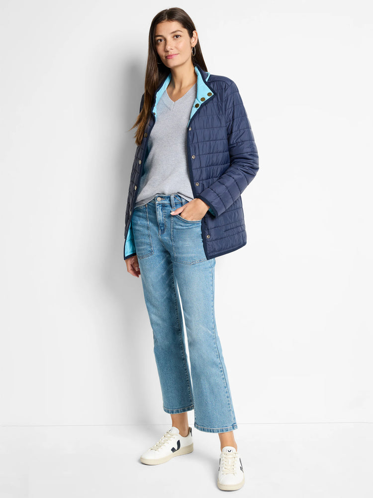 Navy blue quilted jacket with light blue lining, shown over a light gray V-neck sweater.